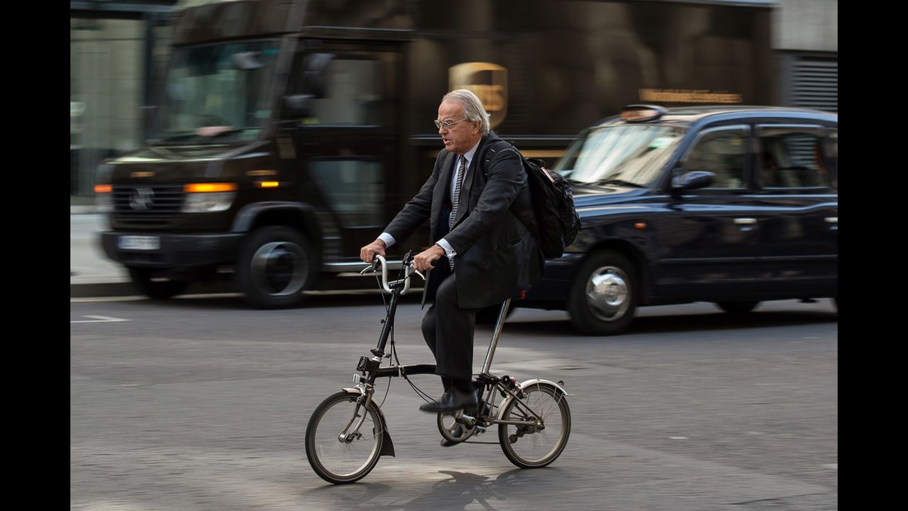 A commuter rides a bike through traffic in London on July 9. Commuters and tourists had to find their way to their destinations by bus, train, bicycle, taxi or on foot.