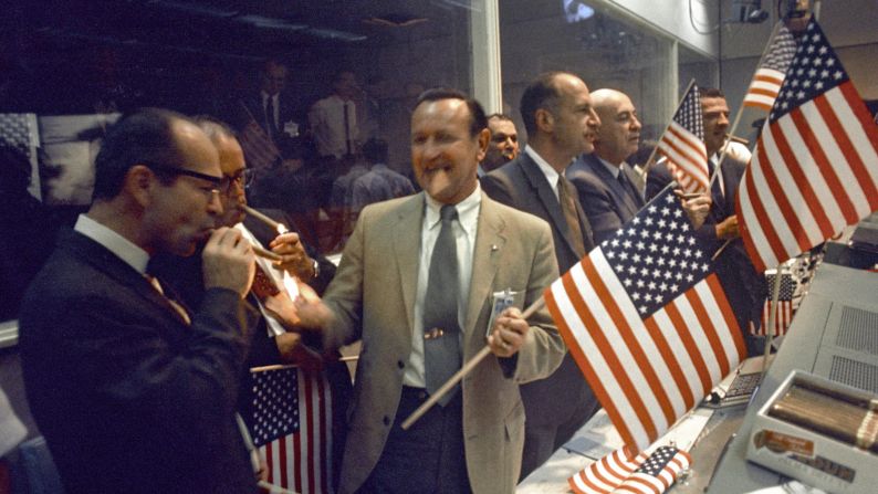 Back on Earth, NASA officials celebrate the successful conclusion of Apollo 11's eight-day mission.