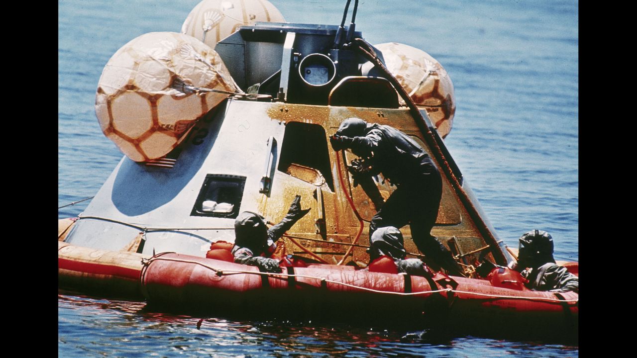 The U.S. Navy assists the returning astronauts after their re-entry vehicle landed safely in the Pacific Ocean on July 24, 1969.