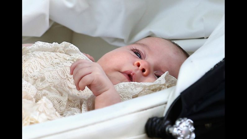 Charlotte is pushed in her pram following her christening.