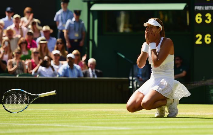 After hitting a winner on match point, Muguruza crumpled to the famous grass. She's the first Spanish woman to play in a grand slam final in 15 years.