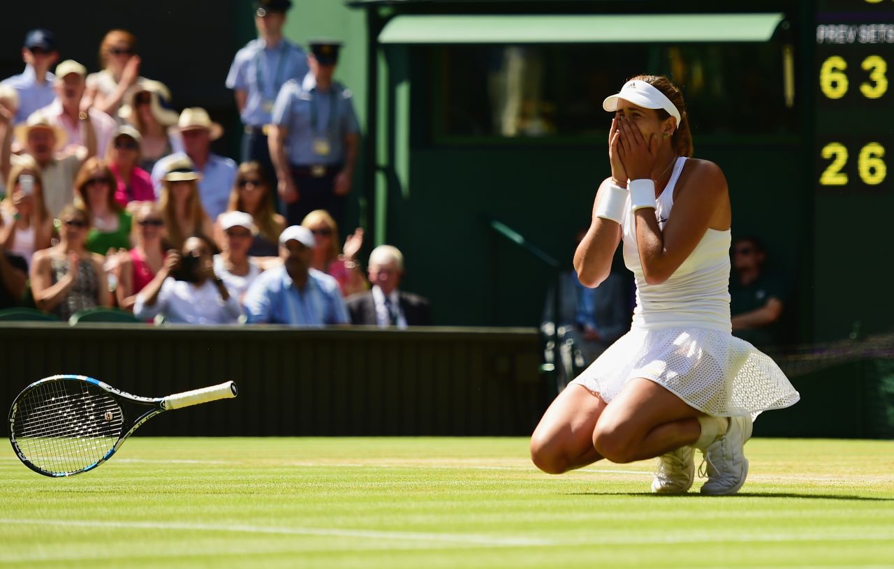 After hitting a winner on match point, Muguruza crumpled to the famous grass. She's the first Spanish woman to play in a grand slam final in 15 years. 