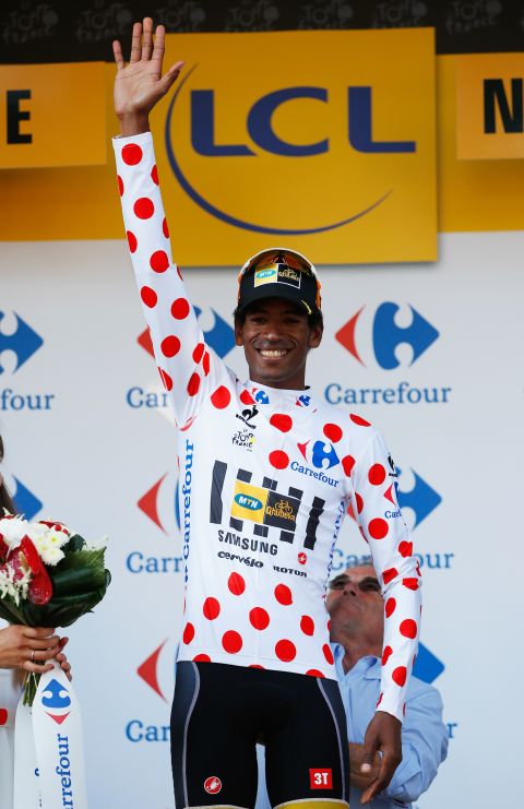Daniel Teklehaimanot of Eritrea and MTN-Qhubeka celebrates as he becomes the first African to hold the polka-dot jersey for points gained on climbs during a Tour de France.<br />