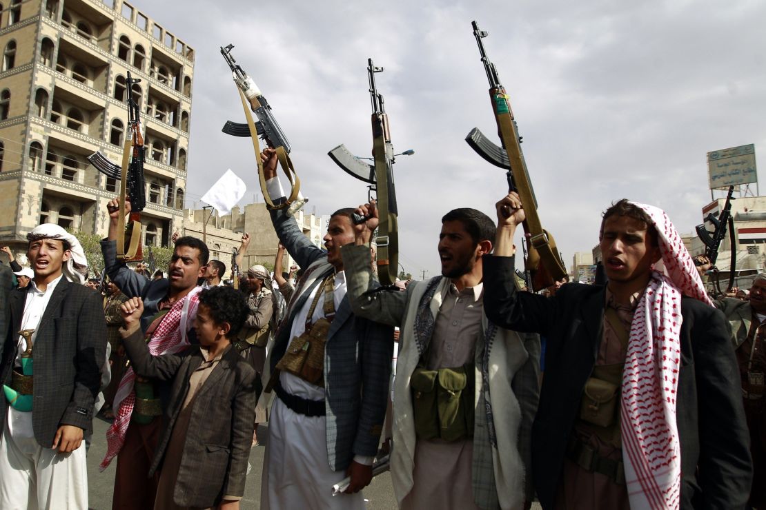 Yemeni supporters of the Shiite Houthi movement raise their weapons during a rally in the capital Sanaa 