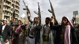 Yemeni supporters of the Shiite Houthi movement raise their weapons during a rally in the capital Sanaa 