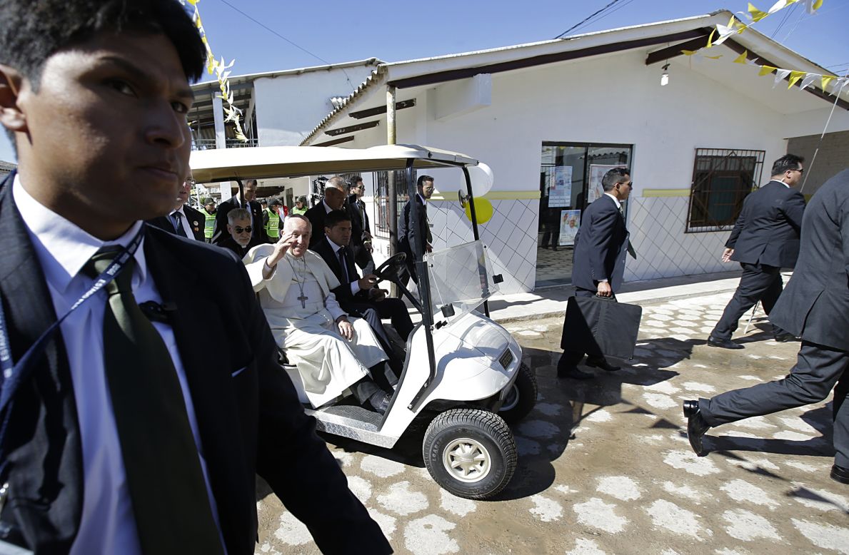 Pope Francis waves from a golf cart after visiting with prisoners in Santa Cruz, Bolivia, on July 10. The Pope wrapped up his trip to Bolivia with a visit to its notoriously violent and overcrowded Palmasola prison. 