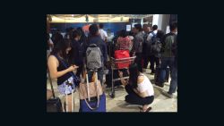 Stranded travelers wait at Jakarta International Airport on July 10 after volcanic ash in Indonesia caused flight cancellations and airport closures.