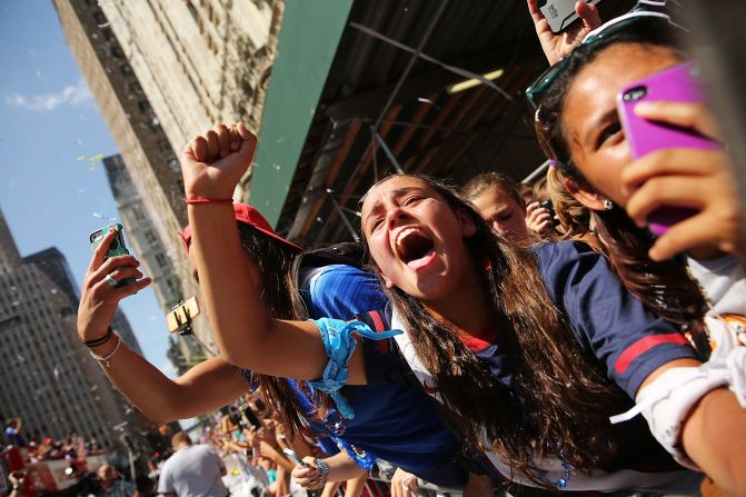 Fans cheer and take photos during the parade. The last time female athletes paraded along the Canyon of Heroes was in 1984.