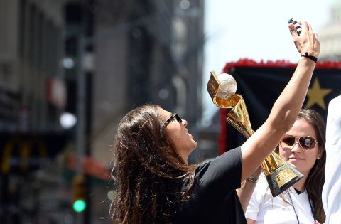 U.S. midfielder Carli Lloyd takes a selfie with the World Cup 2015 trophy during the ticker tape parade.