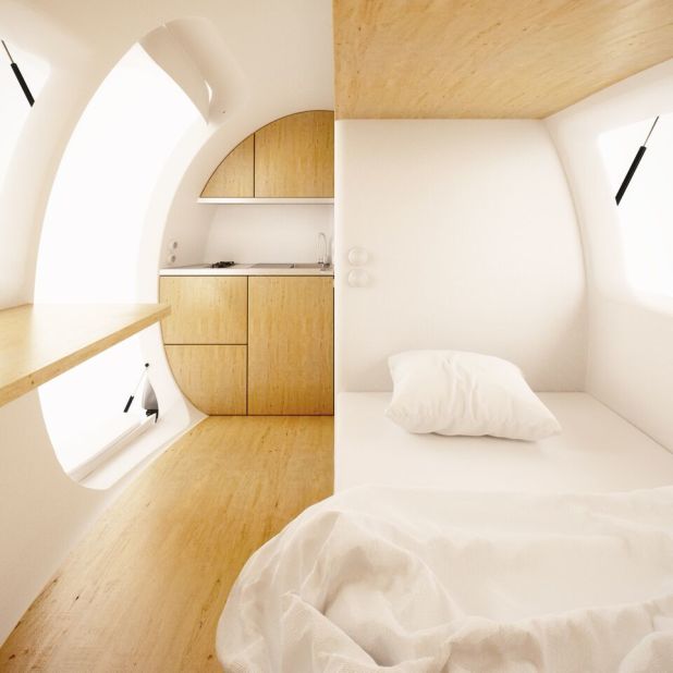 The capsule makes ingenious use of interior space, including a bedroom, kitchenette, workspace, dining room and en-suite bathroom. 