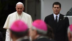 Pope Francis is received by Paraguayan President Horacio Cartes upon his arrival in Asuncion, Paraguay on July 10, 2015. AFP PHOTO/PABLO PORCIUNCULAPABLO PORCIUNCULA/AFP/Getty Images