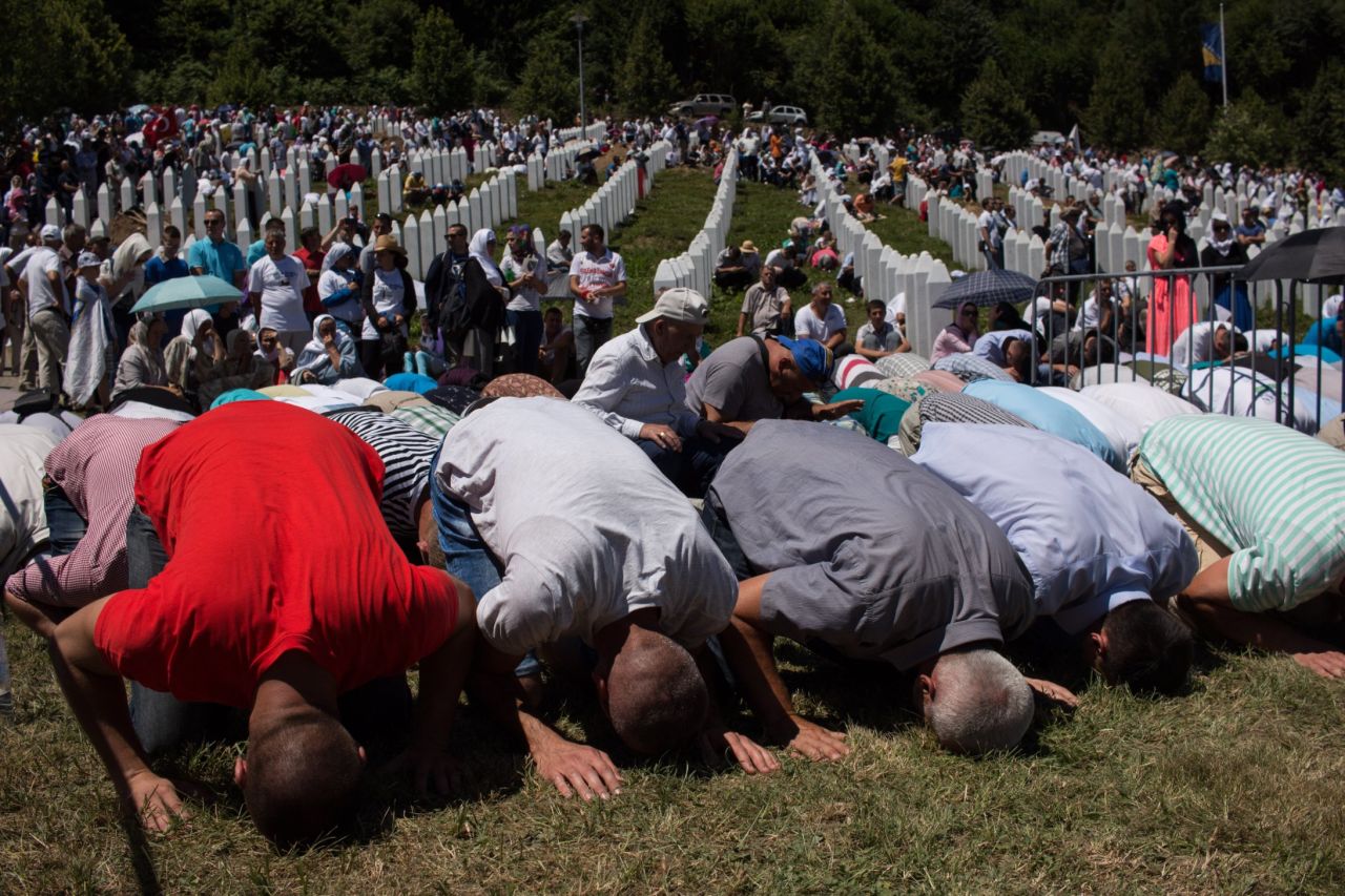 Thousands of mourners pray beside the graves of more than 6,000 people murdered in the Srebrenica genocide. Around 8,000 are believed to have been killed in total.