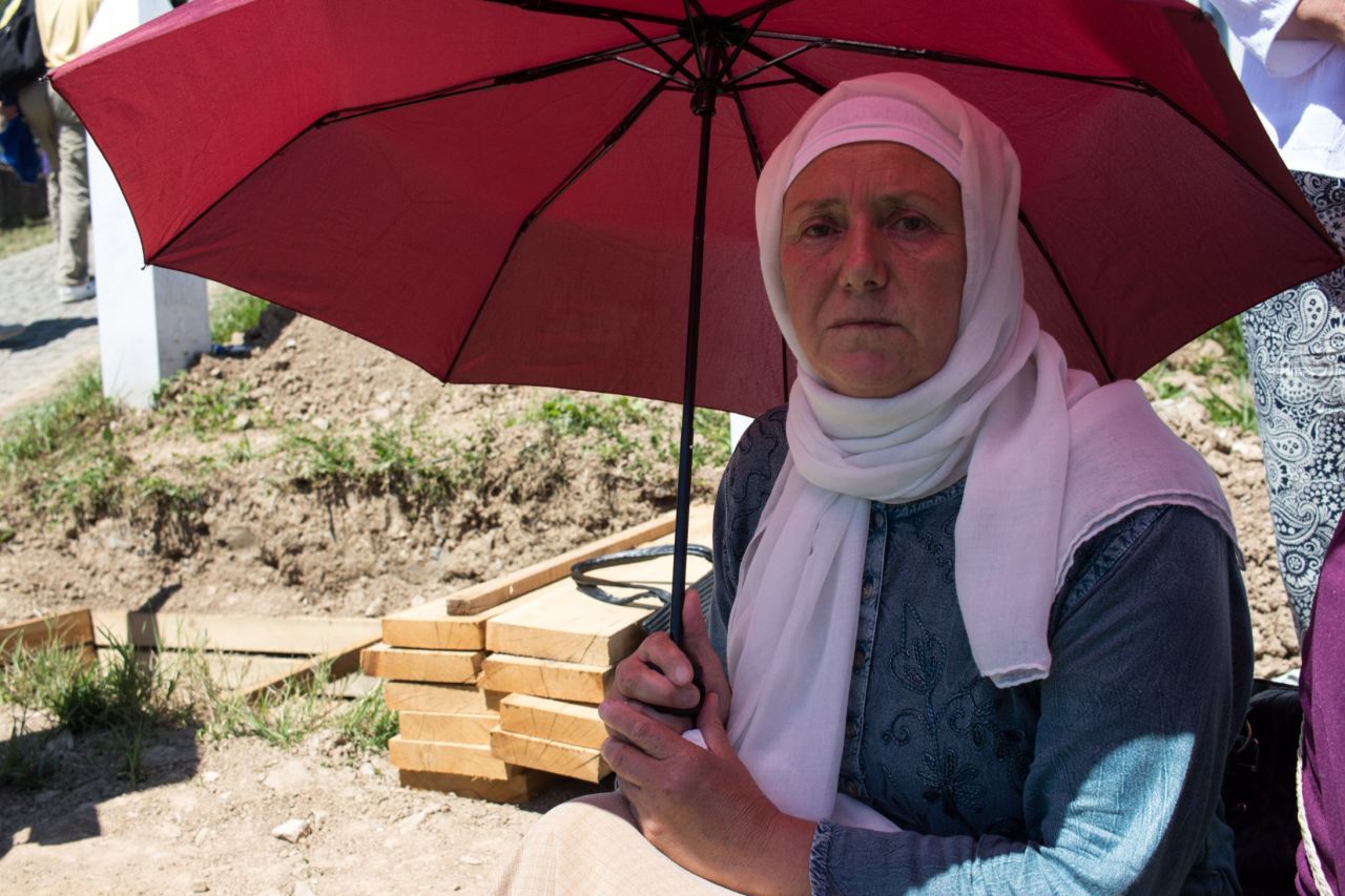Hadzira Dozic's brother was 32 when killed in 1995. She sits beside an open grave, waiting for his remains to finally be buried. Her husband and three of his brothers were also killed, along with around 30 other family members. "It can never be done. How can it be done?"