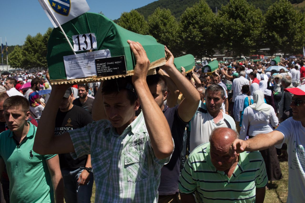 Men carry coffins to be buried.