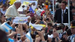 Pope Francis makes his way through the streets of Caacupe as he heads to the Marian Shrine of Caacupe, to deliver mass to hundreds of thousands of pilgrims on July 11.