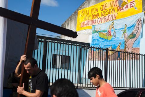 Volunteers at the San Juan chapel carry crosses to the stage where Pope Francis will sit when he visits the impoverished Bañado Norte neighborhood on Sunday, July 12.