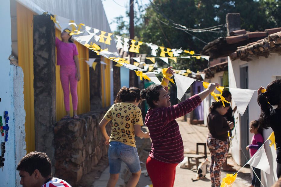 Mercedes Paredes decorates her neighborhood where Pope Francis will visit three families during his visit in Asuncion. 