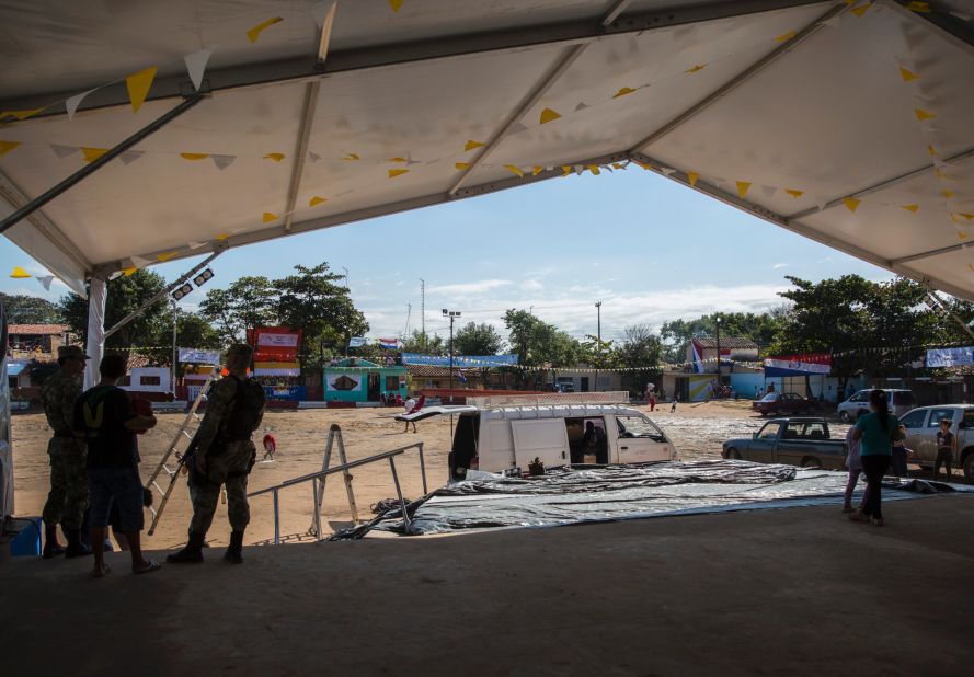 Volunteers decorate and prepare the stage for Pope Francis' arrival on Sunday, July 12. The area has been flooded countless times, leaving many homes in shambles, but people feel renewal knowing of the Pontiff's visit.