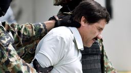 Joaquin "El Chapo" Guzman is escorted by marines as he is presented to the press on February 22, 2014, in Mexico City.