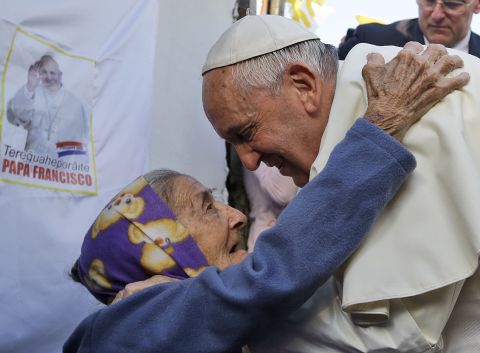 An elderly woman greets the Pope during his visit to the Banado Norte neighborhood in Asuncion on July 12.