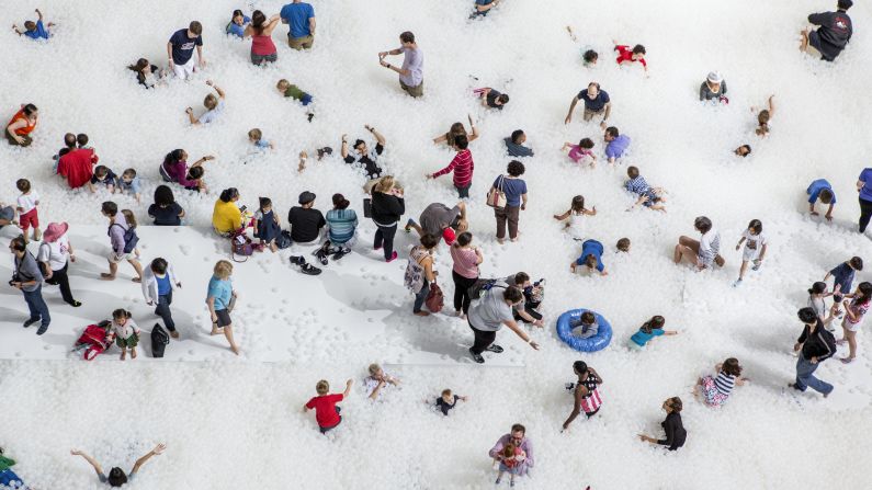 The interactive installation features an ocean of nearly 1 million translucent plastic balls.