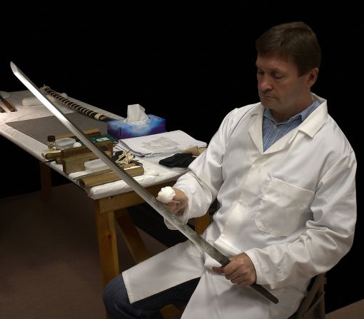 Swords can be maintained for centuries through careful polishing, as demonstrated here by British expert Paul Martin. 