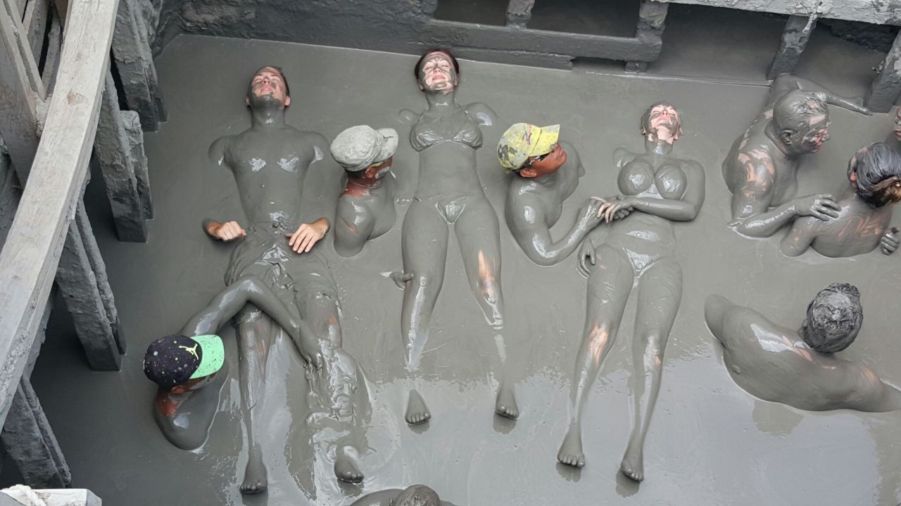 Colombia's mud volcano -- Volcán de Lodo El Totumo -- may be the country's messiest attraction. Attendants (in hats) slather bathers in mud once they're inside the volcano.