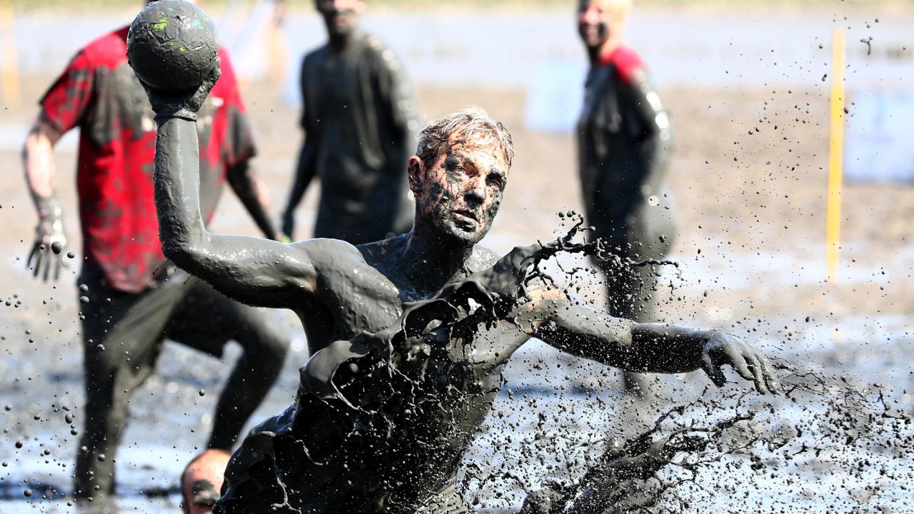 A man plays handball Saturday, July 11, during the Mudflat Olympic Games in Brunsbuttel, Germany.