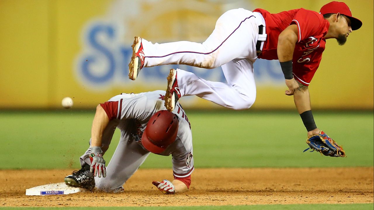 Arizona's A.J. Pollock slides safely into second base as the ball flies past Texas' Rougned Odor on Tuesday, July 7.