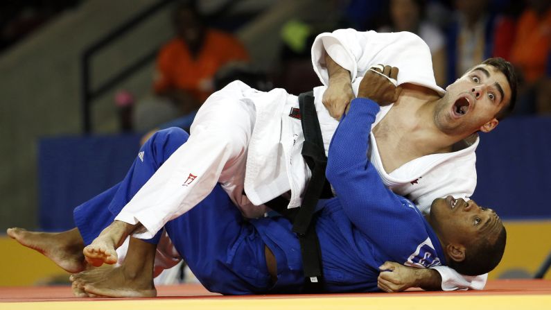 Canadian judoka Antoine Bouchard, top, reacts as the referee gives him the win over Cuba's Carlos Tondique at the Pan American Games on Sunday, July 12.