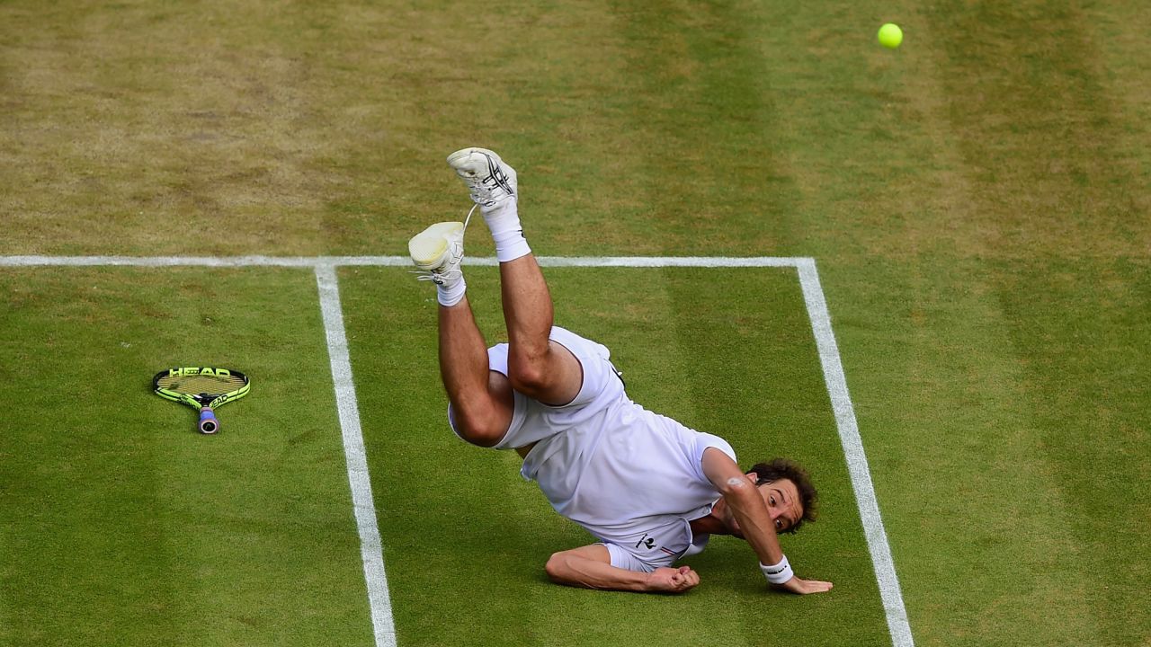 Richard Gasquet falls to the ground while playing Stanislas Wawrinka in the Wimbledon quarterfinals on Wednesday, July 8. Gasquet won the match in five sets, with the final set finishing 11-9.