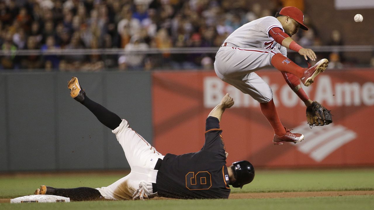 Philadelphia shortstop Freddy Galvis, top, loses the ball after forcing out San Francisco's Brandon Belt on Saturday, July 11.