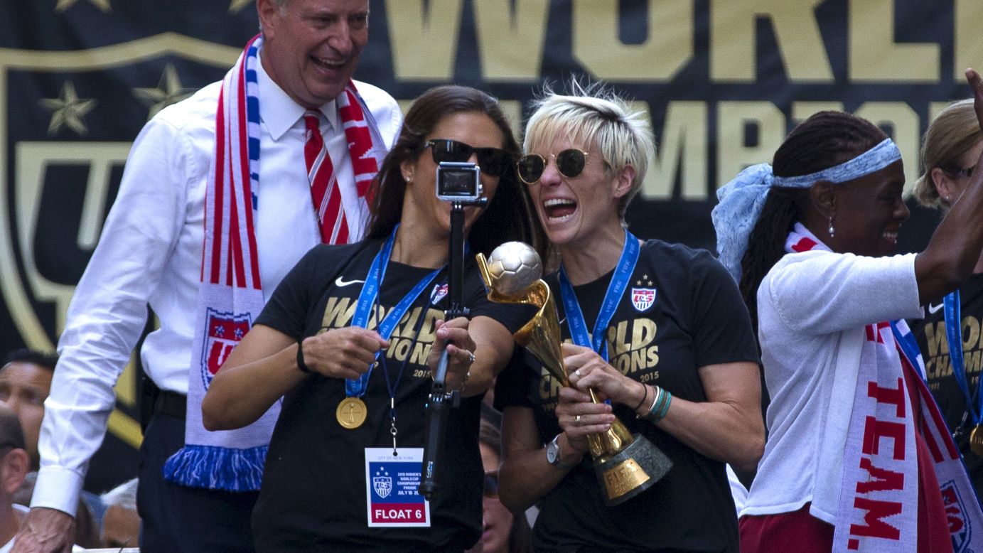 U.S. soccer players Carli Lloyd, left, and Megan Rapinoe take a selfie with the Women's World Cup trophy <a href="http://www.cnn.com/2015/07/10/us/gallery/us-soccer-team-parade/index.html" target="_blank">during a parade in New York City</a> on Friday, July 10. Behind Lloyd and Rapinoe is New York Mayor Bill de Blasio.