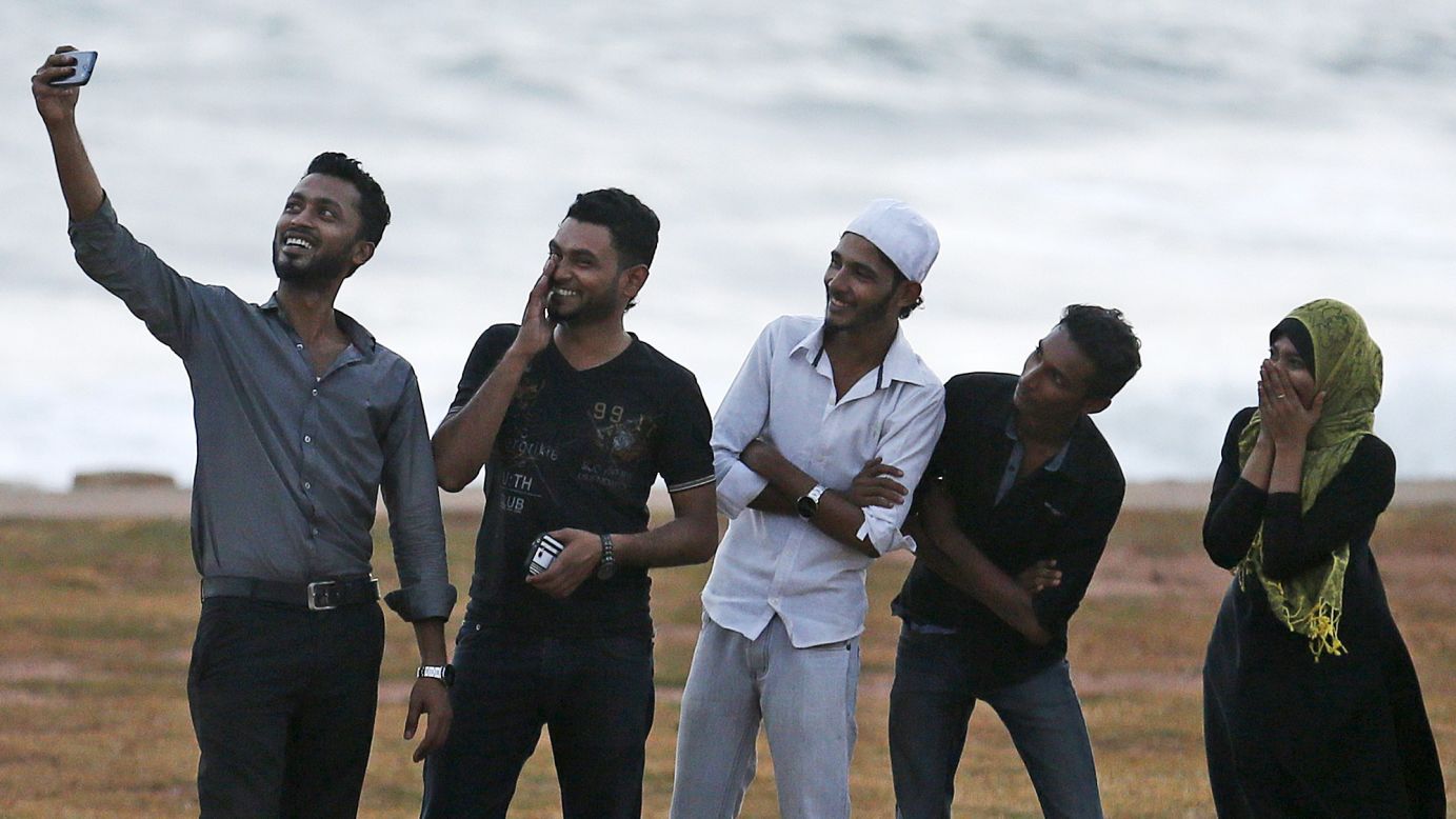 A man takes a selfie with his friends in Colombo, Sri Lanka, before breaking fast on Wednesday, July 8. During the holy month of Ramadan, Muslims abstain from food and drink during daylight hours.<br />