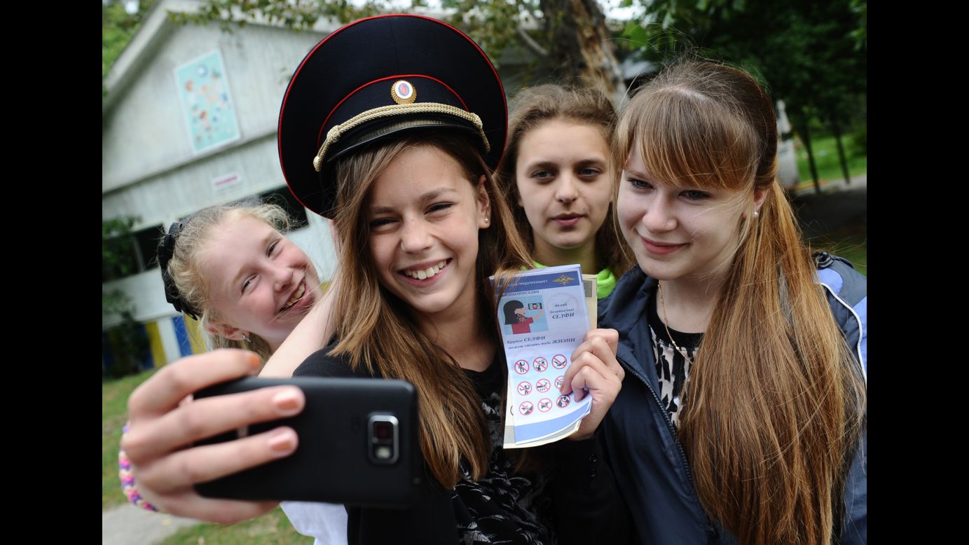 A girl in Russia's Ryazan region takes a selfie with a leaflet, released by the country's Interior Ministry, that urges "safe selfie" practices on Monday, July 13. Russia <a href="http://www.cnn.com/2015/07/08/asia/russia-selfie-death-brochure/" target="_blank">launched the safe-selfie campaign</a> after a spate of recent selfie-related accidents.