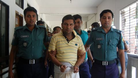 Bangladeshi police escort a suspect in the beating death of a 13-year-old boy in Sylhet.