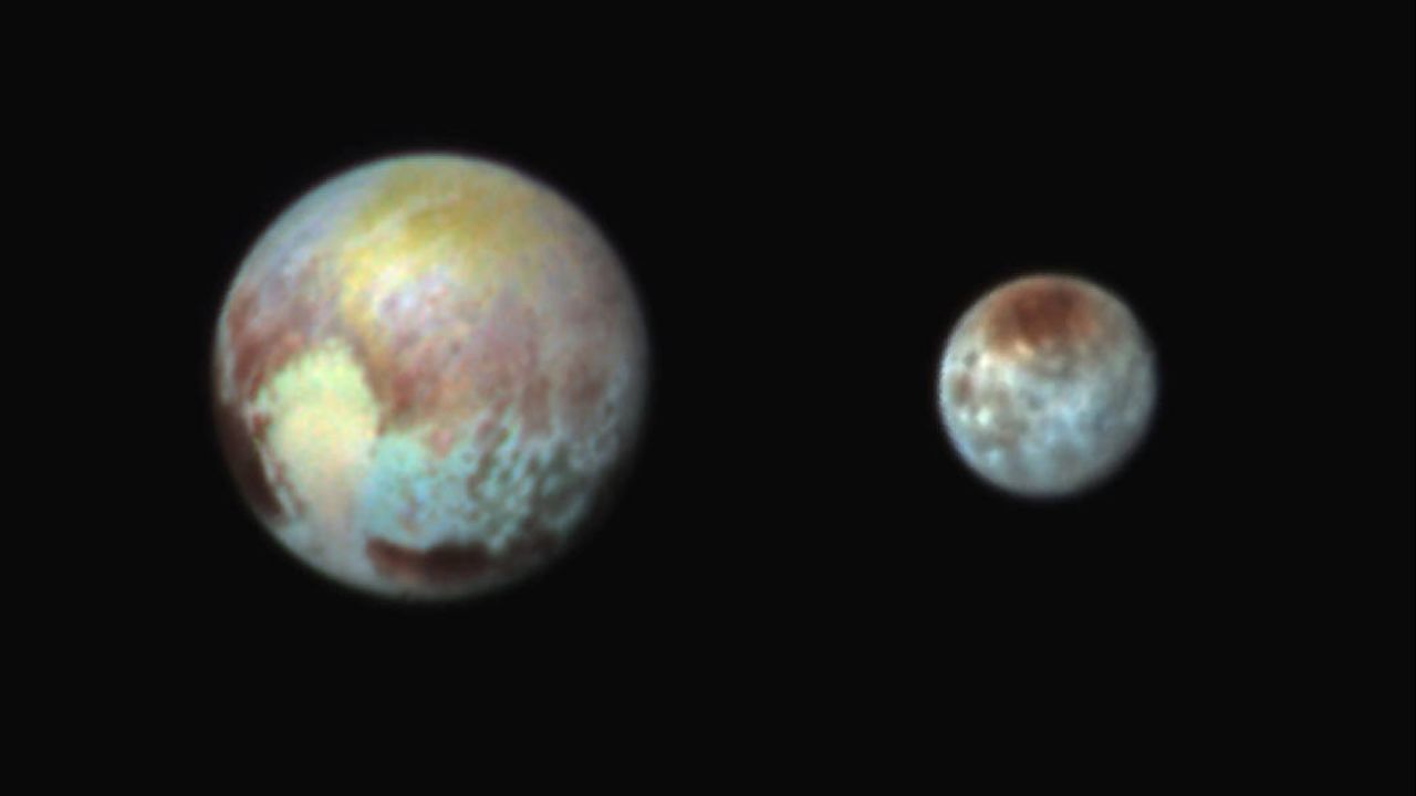 The colors in this image of Pluto and Charon are exaggerated to make it easy to see their different features. (These are not the actual colors of Pluto and Charon, and the two bodies aren't really that close together in space.) This image was created on July 13, one day before New Horizons was to make its closest approach to Pluto.
