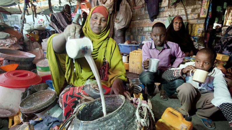 Deliciously sweet milky Somali tea brewed in great vats at what seems like every street corner. Here, two boys are having a fresh cup of Somali yogurt, made from cow milk.
