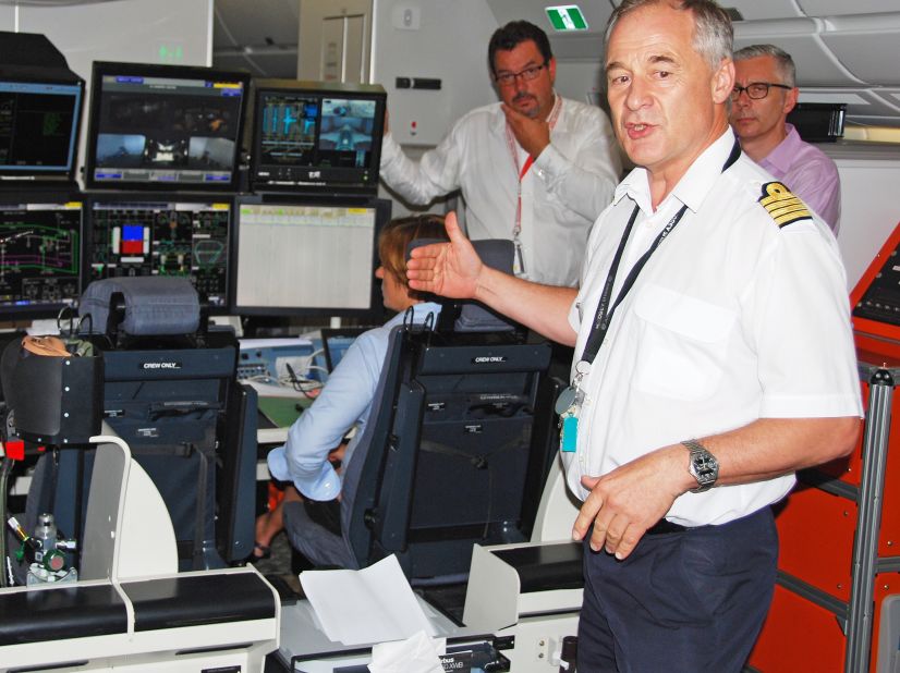 Airbus test pilot Frank Chapman explains a flight test data station aboard the A350 during its stop in Atlanta on Tuesday. Chapman was accompanied by Mike Bausor, left, Airbus A350XWB marketing director and Chris Jones of Airbus North American sales.