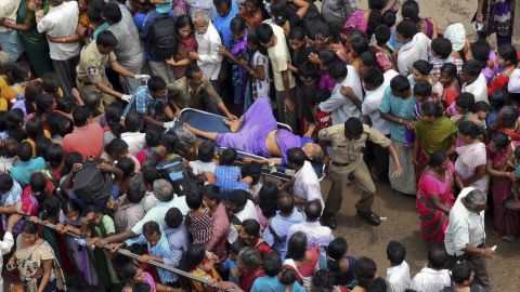 A woman is rushed to a hospital on a stretcher after the stampede.