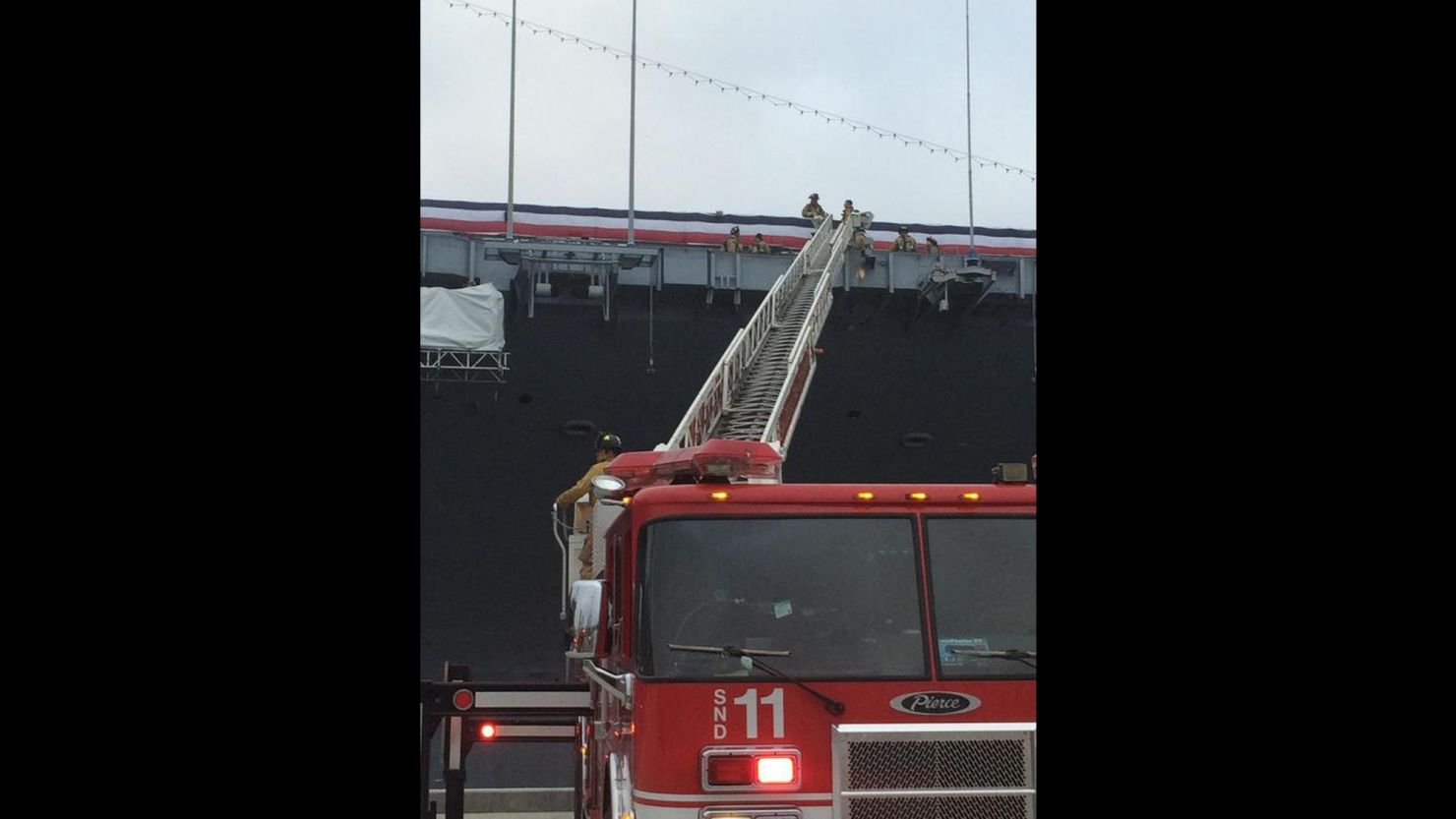 A San Diego fire department ladder extends onto the USS Midway.
