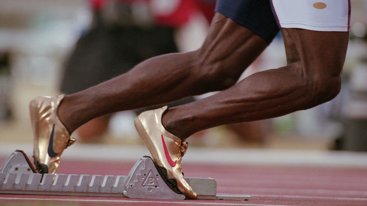 U.S. sprinter Michael Johnson wears gold Nike shoes at the 1996 Olympic Games in Atlanta. Johnson was one of the major stars of the Olympics, winning the 200 meters and the 400 meters in record time.