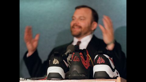 Ibrahim Hooper, communications director of the Council on American-Islamic Relations, gestures during a June 1997 news conference with samples of Nike shoes in the foreground. Hooper's group said the "Air" symbol resembled "Allah" in Arabic, and the shoes were recalled. Nike apologized to Muslims for any unintentional offense.