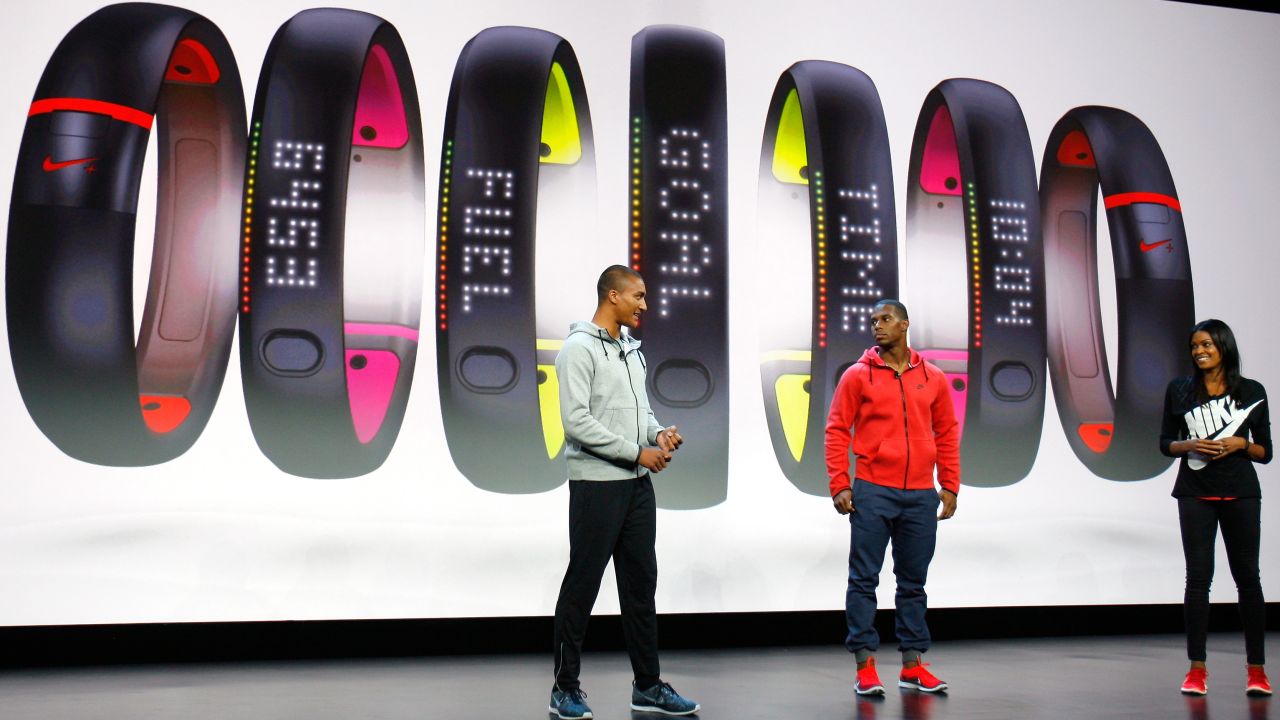 Olympic decathlete Ashton Eaton, left, and pro football player Victor Cruz speak at a Nike event in New York in October 2013. Nike was introducing its FuelBand activity tracker, continuing to expand its business past more than shoes. The company also makes equipment for just about every sport.