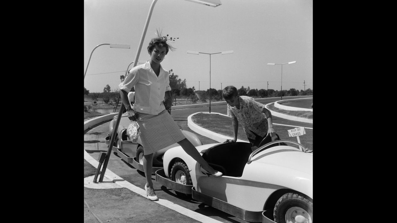 After a $17 million investment and a year of construction on the 160-acre former orange grove, Walt Disney's biggest gamble was scheduled to open. Actress Adelle August is shown here stepping into the Autopia ride, which was working that day. But little else was in order. Some street asphalt was still soft, paint was still drying and workers were still planting trees. And park officials had underestimated demand: Some 15,000 invitations had been printed for the special day, according to one account, but counterfeiters were at work and crowd estimates went as high as 28,000 visitors. 