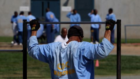 An inmate at the Mule Creek State Prison exercises through pull-ups in an outside yard August 28, 2007 in Ione, California. 