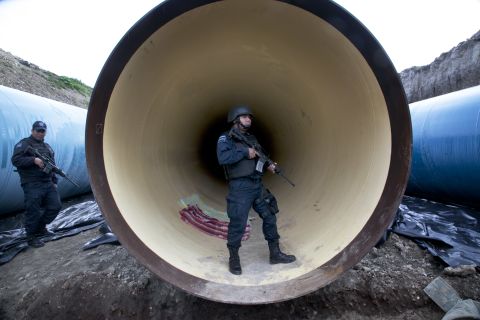 Federal police guard a drainage pipe outside of the prison on Sunday, July 12.