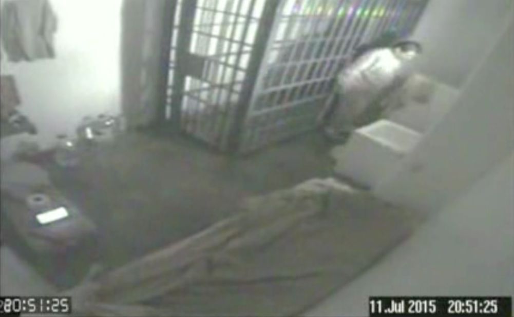 This screen grab of security video, dated July 11 and released by Mexico's National Security Commission, shows Guzman inside his cell at the Altiplano prison in Almoloya de Juarez, Mexico. He is looking at the shower floor shortly before escaping through a tunnel below, authorities said.