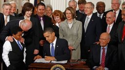  President Obama  signs the Affordable Health Care for America Act during a ceremony with fellow Democrats in the White House. The law is an attempt to end the Age of Reagan, one writer says.
  