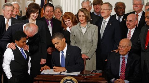  President Obama  signs the Affordable Health Care for America Act during a ceremony with fellow Democrats in the White House on March 23, 2010.  